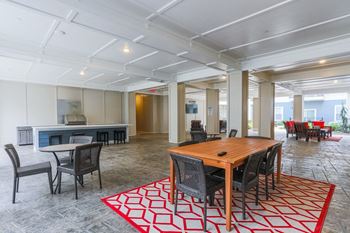 A large living room with a wooden table and chairs